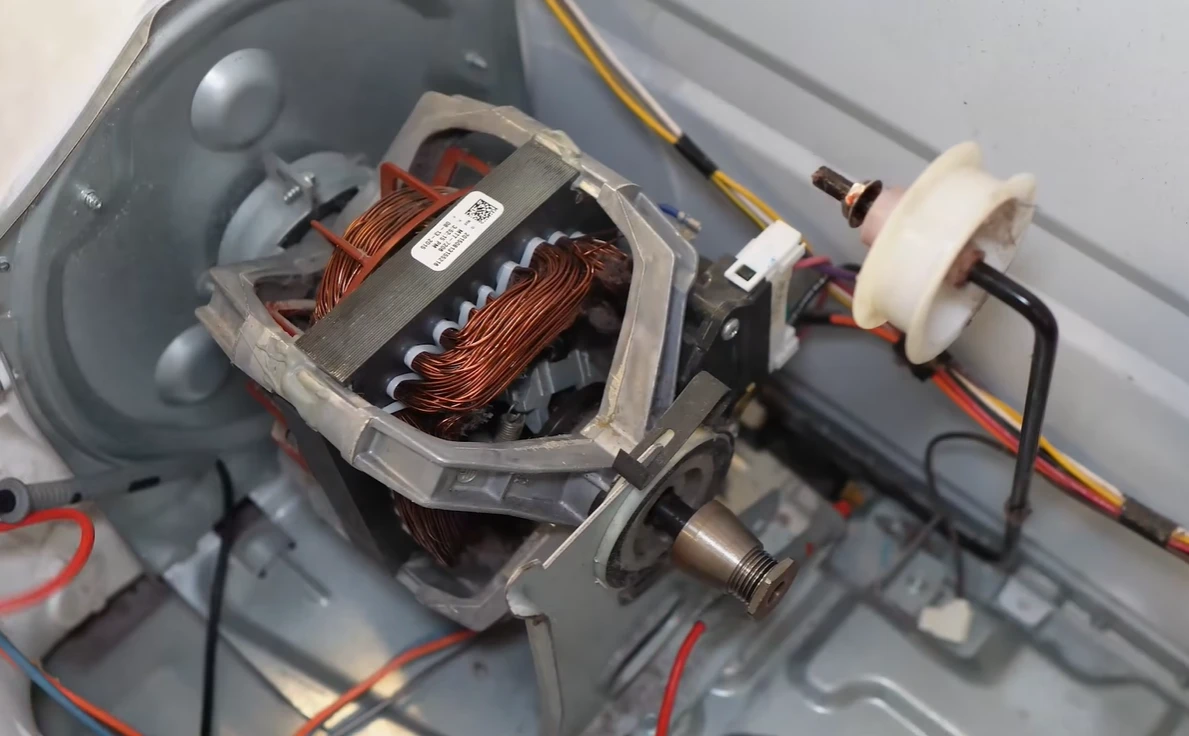 Dryer motor and pulley assembly inside the cabinet