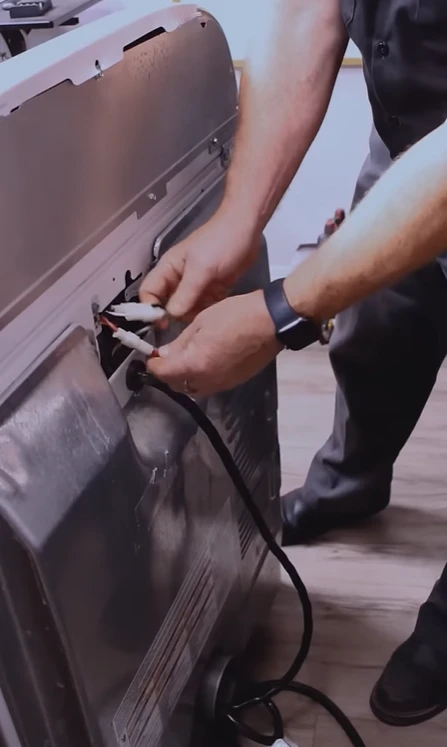 Dryer power cord and terminal connection being inspected